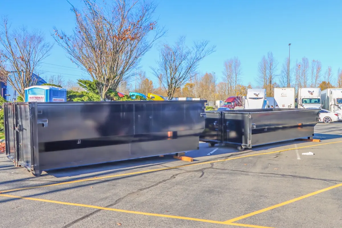 Professional dumpster rental service with roll-off container on residential driveway in Connerton